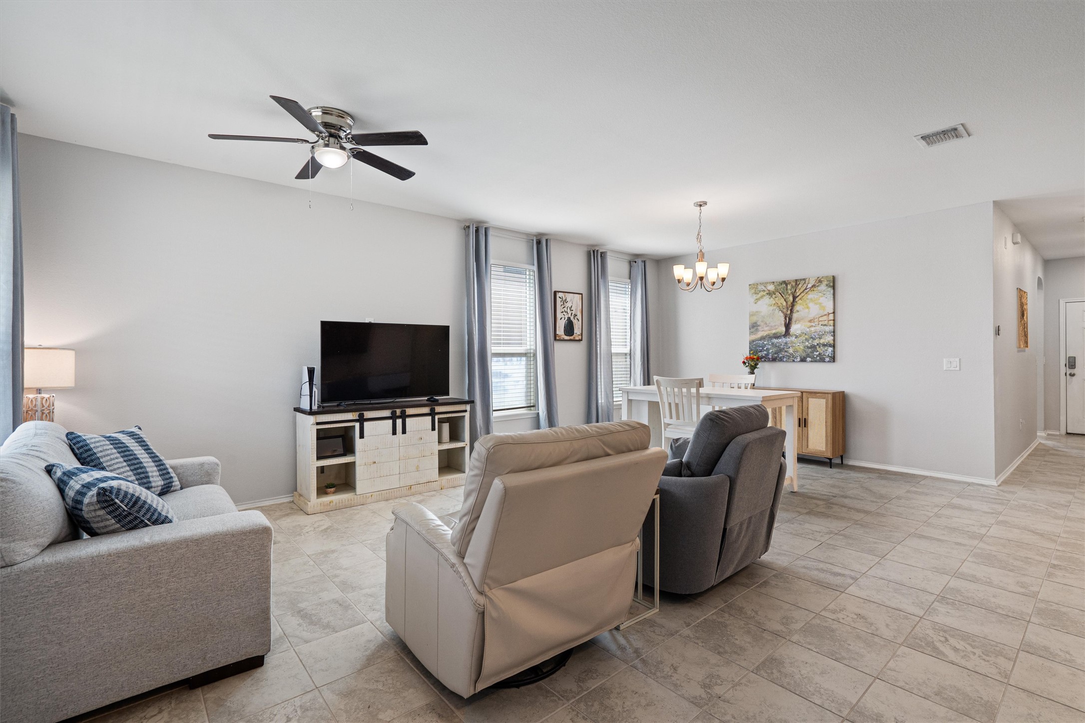 1906 Dragonfly Loop Bastrop, TX 78602 - Photo 11 of 34 a living room with furniture and a flat screen tv