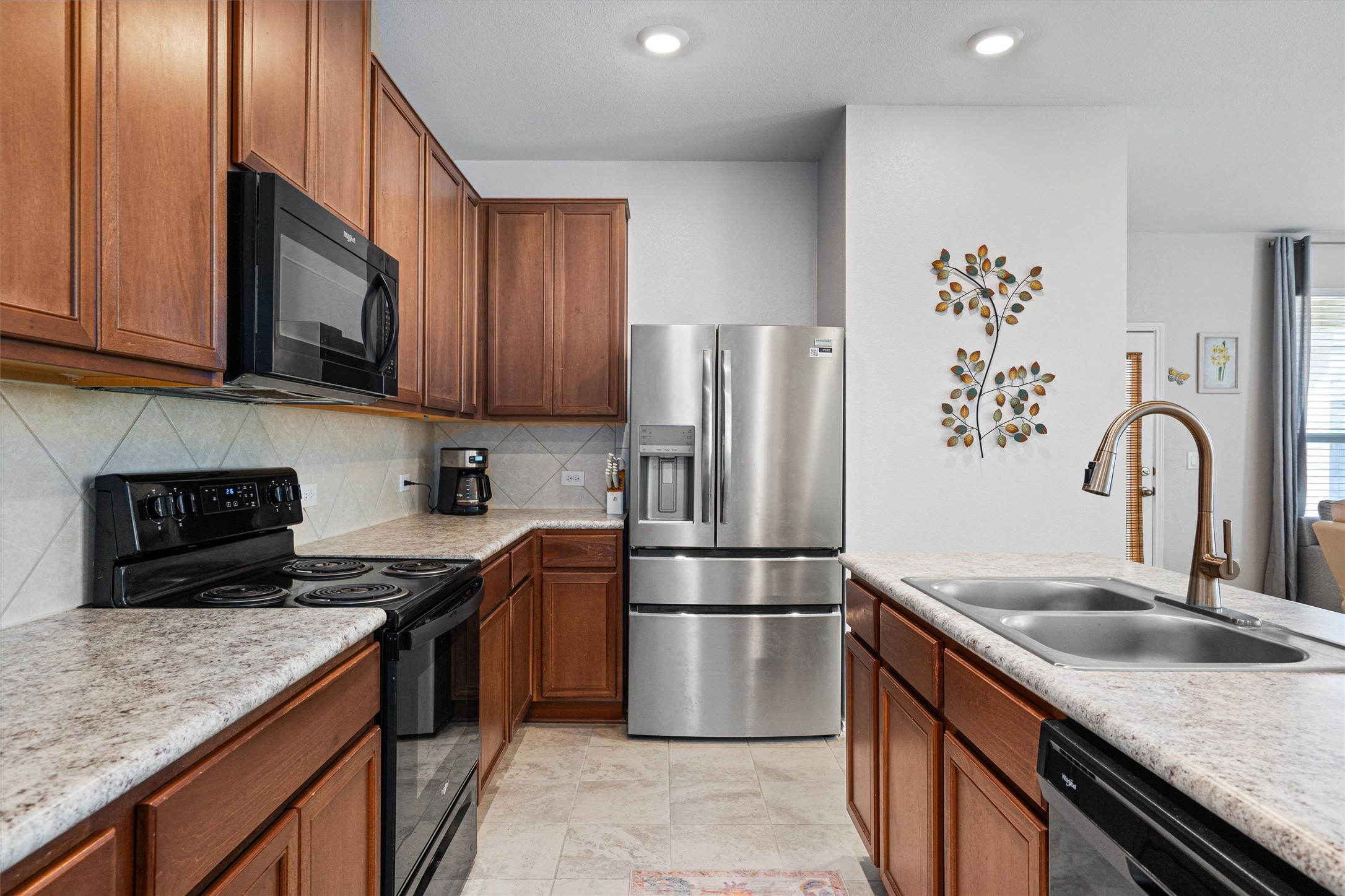 1906 Dragonfly Loop Bastrop, TX 78602 - Photo 14 of 34 a kitchen with granite countertop a refrigerator stove and sink