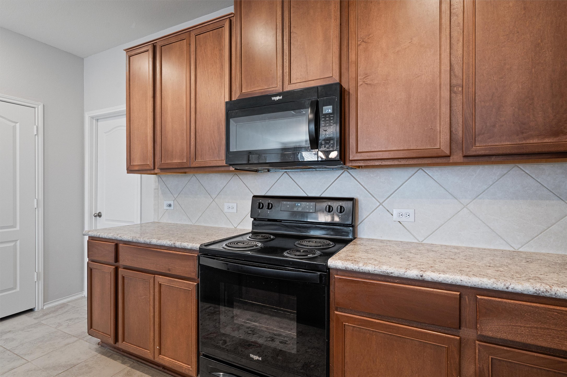 1906 Dragonfly Loop Bastrop, TX 78602 - Photo 15 of 34 a kitchen with granite countertop cabinets stainless steel appliances and a counter space