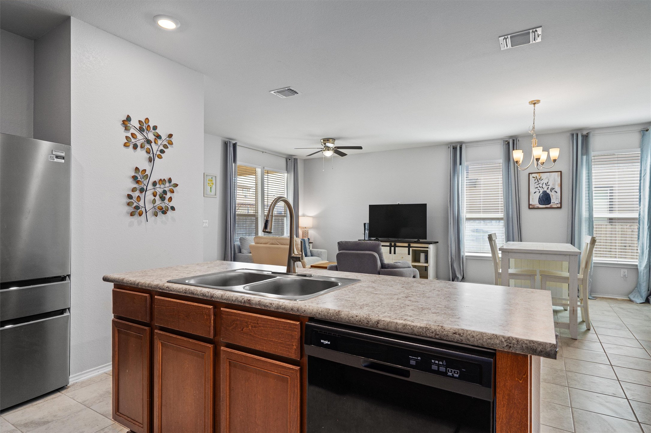 1906 Dragonfly Loop Bastrop, TX 78602 - Photo 16 of 34 a kitchen with stainless steel appliances granite countertop a sink and a refrigerator
