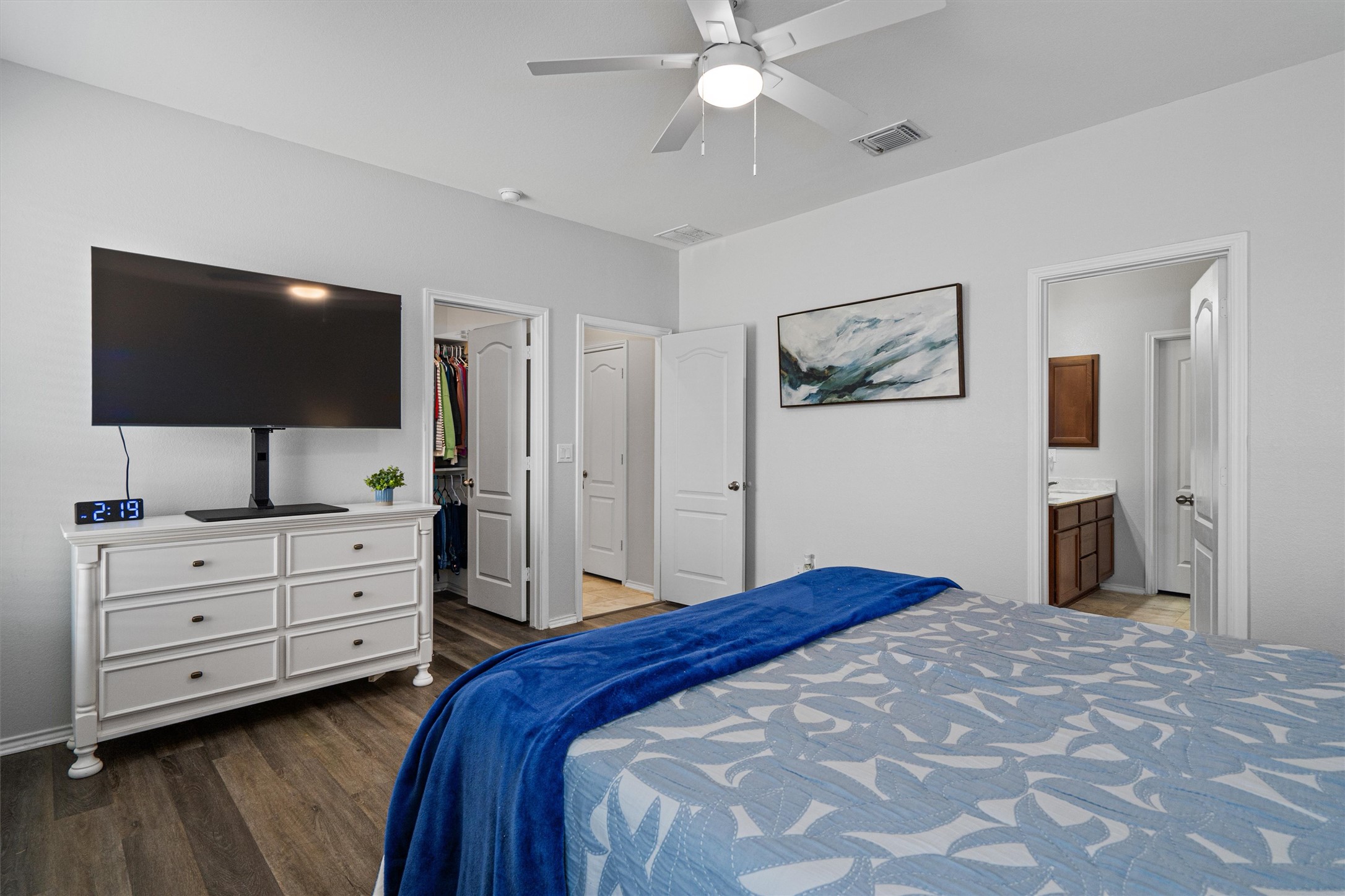 1906 Dragonfly Loop Bastrop, TX 78602 - Photo 18 of 34 a bedroom with a large bed and a flat screen tv