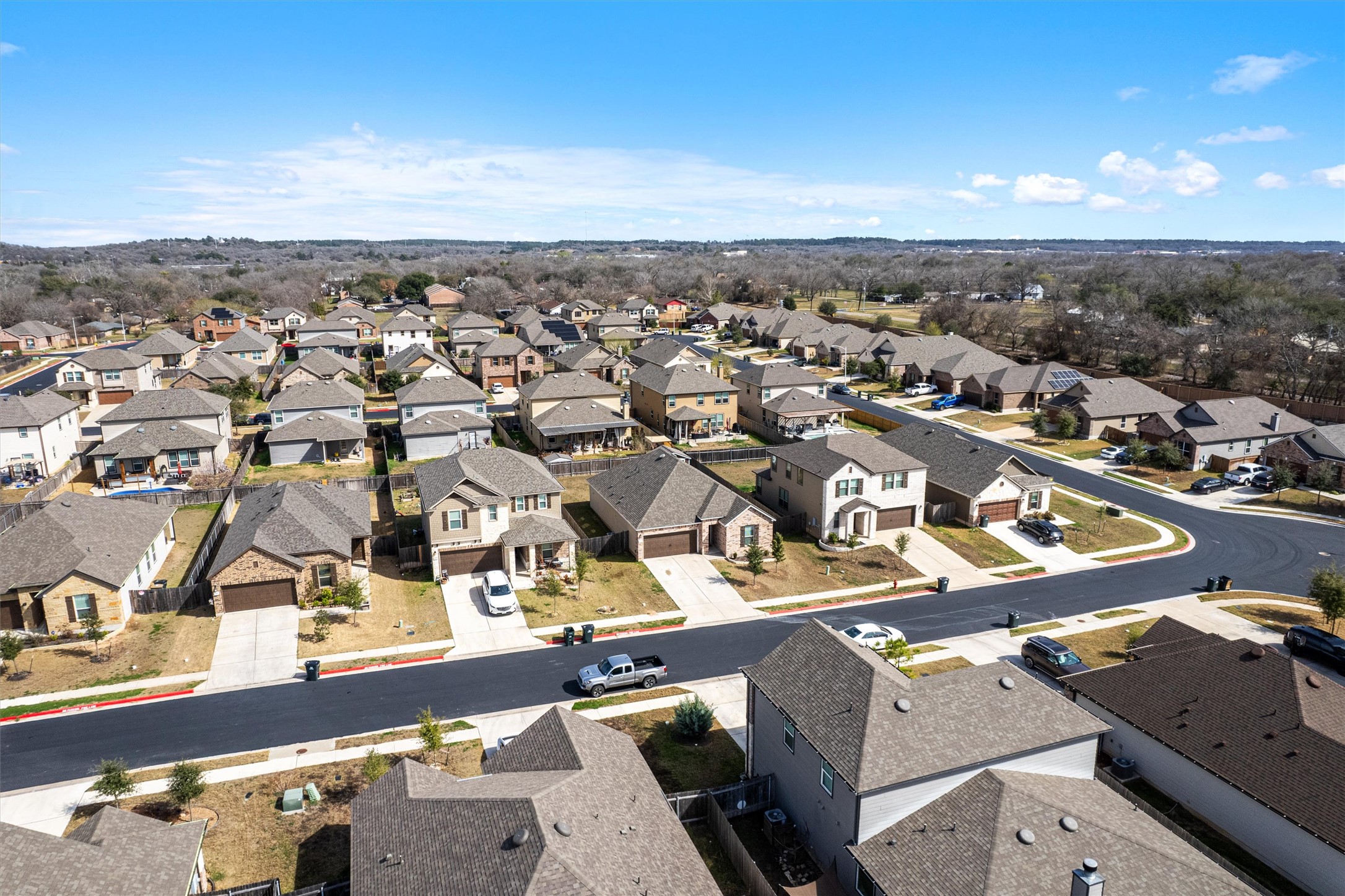 1906 Dragonfly Loop Bastrop, TX 78602 - Photo 2 of 34 an aerial view of residential houses with outdoor space
