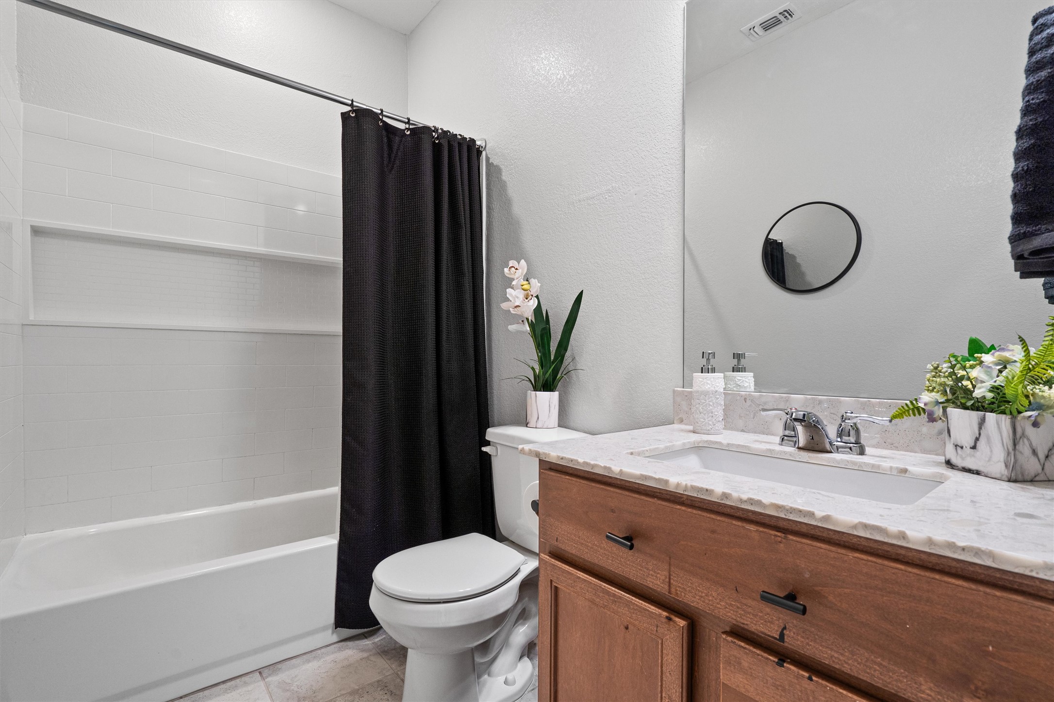 1906 Dragonfly Loop Bastrop, TX 78602 - Photo 26 of 34 a bathroom with a granite countertop sink toilet and shower