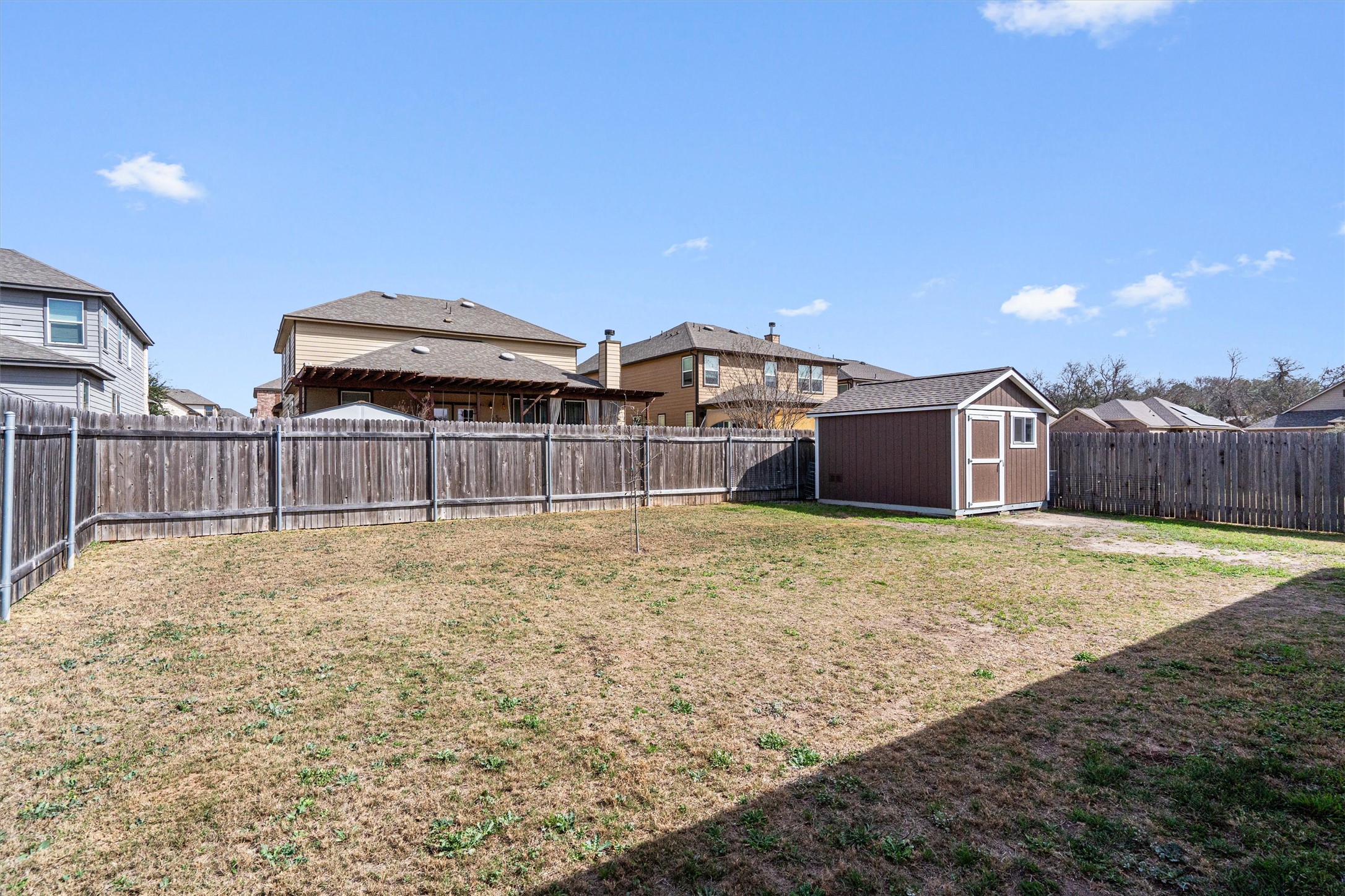 1906 Dragonfly Loop Bastrop, TX 78602 - Photo 31 of 34 a view of a backyard with wooden fence