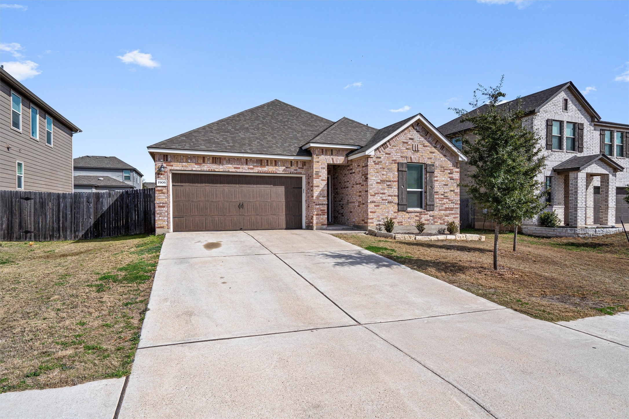 1906 Dragonfly Loop Bastrop, TX 78602 - Photo 4 of 34 a front view of a house with garden