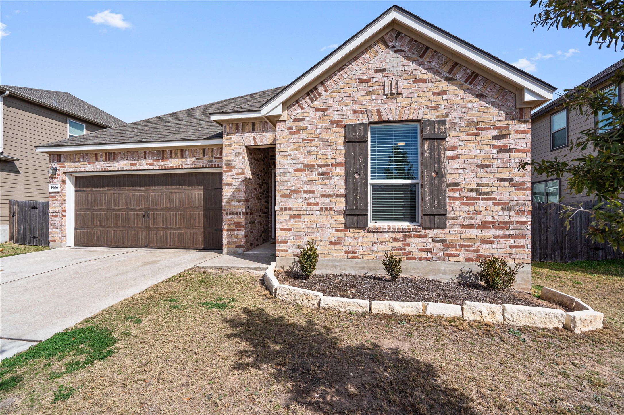 1906 Dragonfly Loop Bastrop, TX 78602 - Photo 5 of 34 a front view of a house with a yard and garage