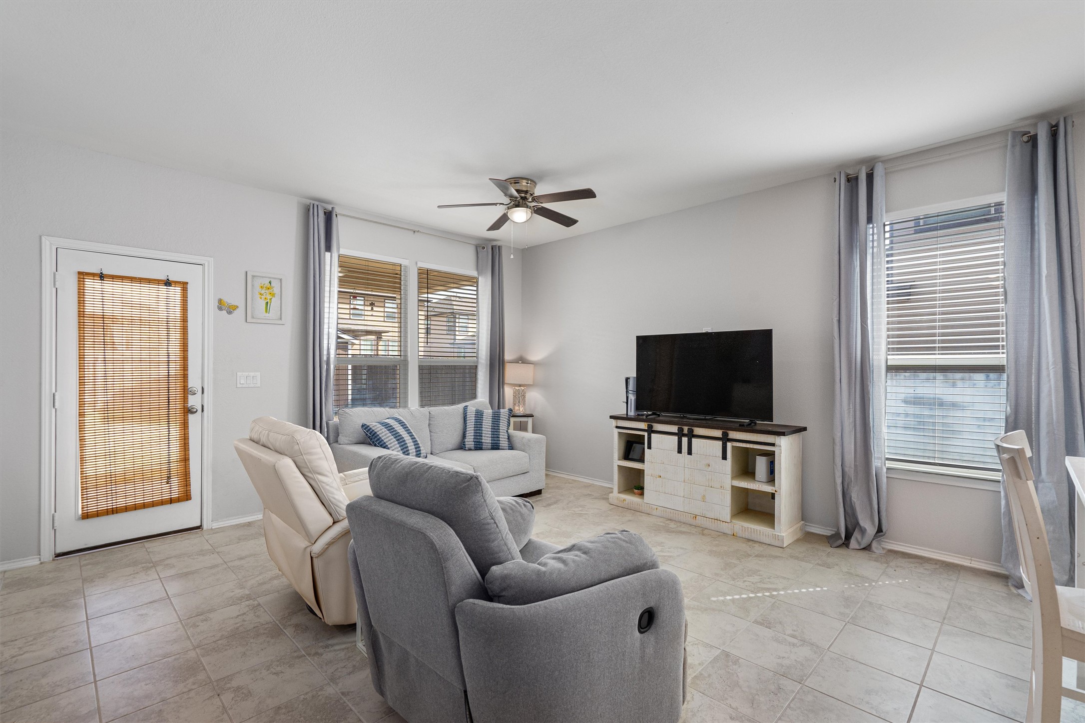 1906 Dragonfly Loop Bastrop, TX 78602 - Photo 8 of 34 a living room with furniture a flat screen tv and a large window