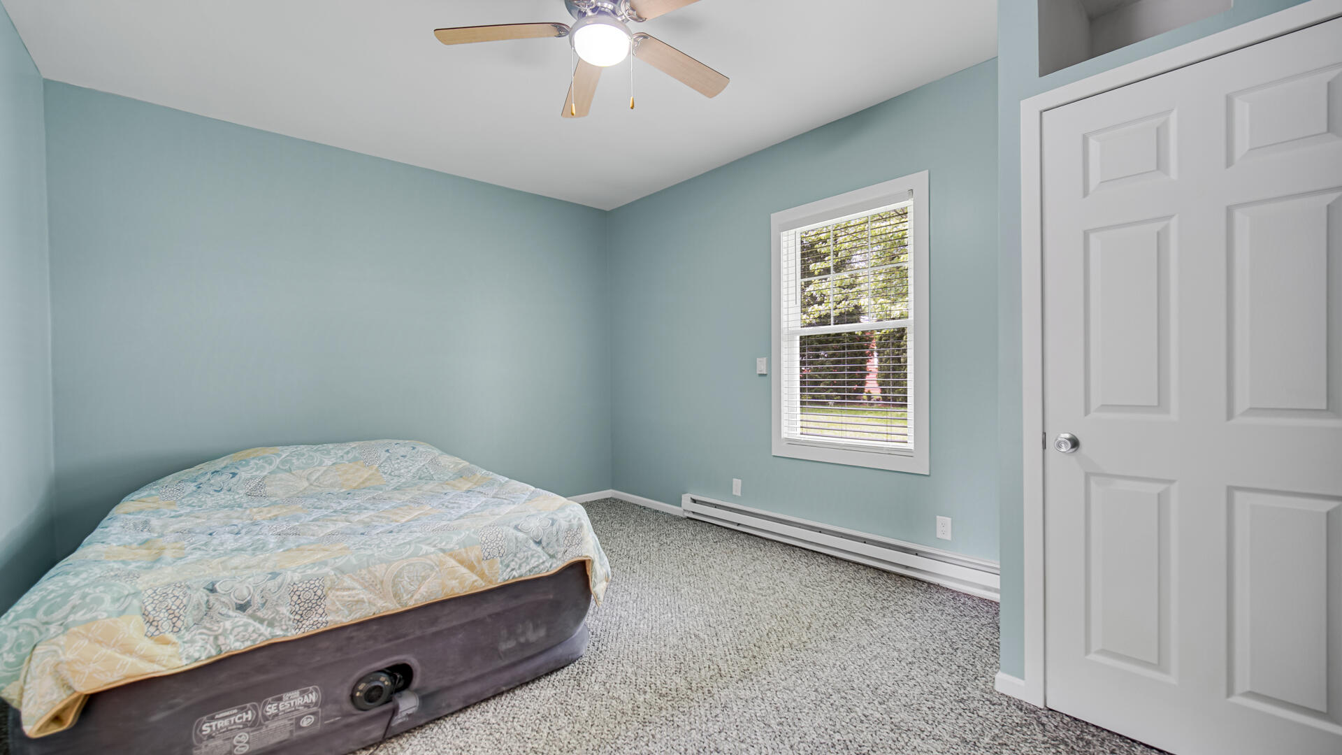 6717 State Rte 49 Rensselaer, IN 47978 - Photo 19 of 31 a room with a bed and a chandelier