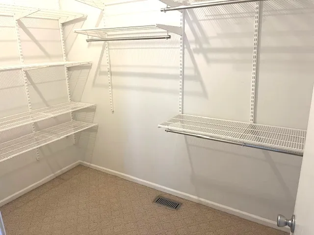 a bathroom with a granite countertop toilet and a sink