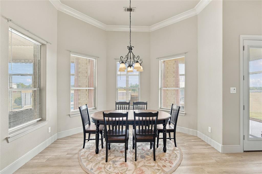 1180 Wiggins Road Maypearl, TX 76064 - Photo 13 of 40 A sunlit dining nook framed by a bay window, ideal for morning coffee or casual meals with a view.