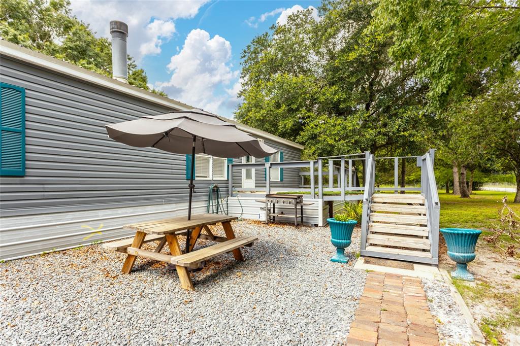 1013 Forest Park Street Bunnell, FL 32110 - Photo 1 of 24 a roof deck with a table and a chairs