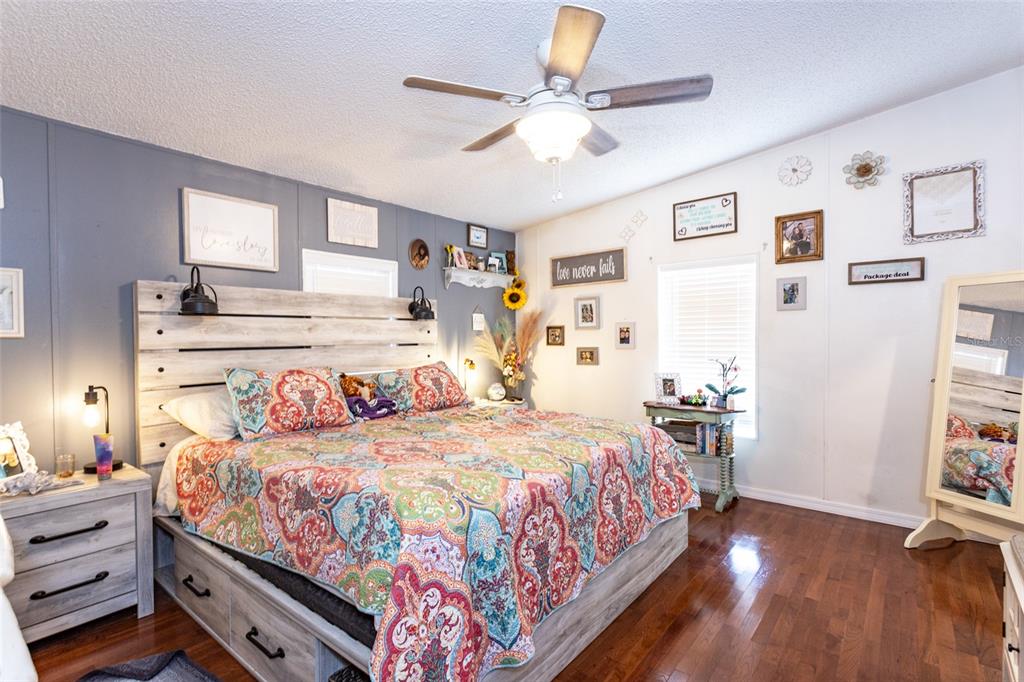 1013 Forest Park Street Bunnell, FL 32110 - Photo 13 of 24 a bedroom with a large bed and a chandelier