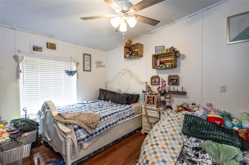 1013 Forest Park Street Bunnell, FL 32110 - Photo 16 of 24 a bedroom with a bed and wooden floor