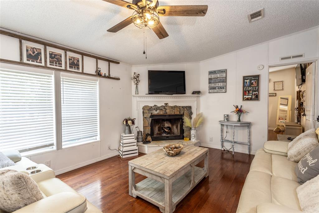 1013 Forest Park Street Bunnell, FL 32110 - Photo 3 of 24 a living room with furniture and a fireplace