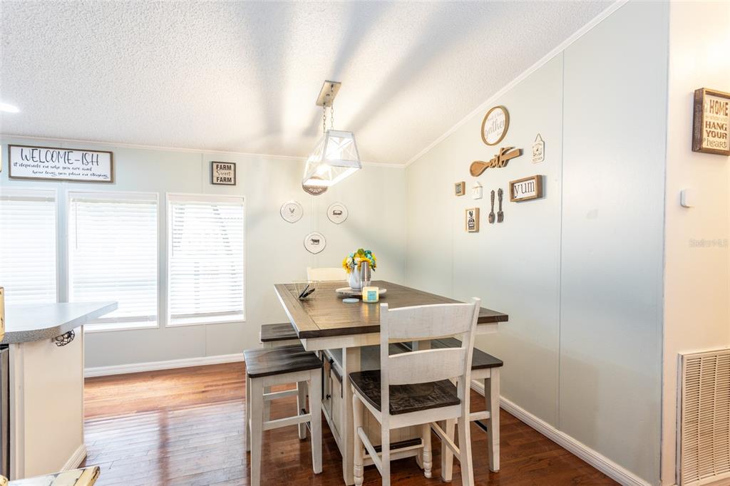 1013 Forest Park Street Bunnell, FL 32110 - Photo 6 of 24 a view of a dining room with furniture and wooden floor