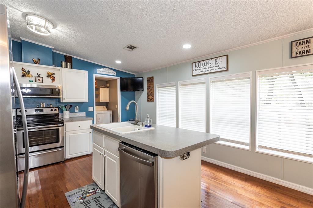 1013 Forest Park Street Bunnell, FL 32110 - Photo 8 of 24 a kitchen with a stove a sink and a refrigerator