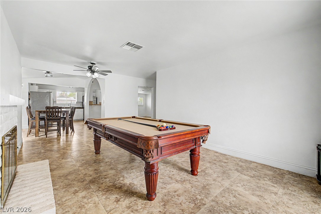 5357 Indian Wells Road Las Vegas, NV 89110 - Photo 18 of 39 A spacious room offers an entertainment zone and casual dining, seamlessly connected to the kitchen.