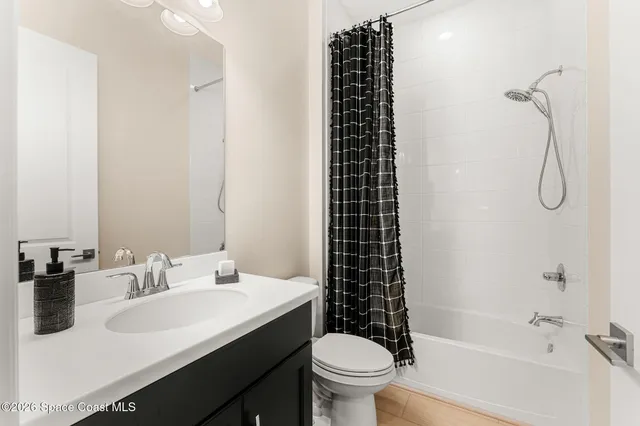 an aerial view of residential houses with outdoor space and ocean view