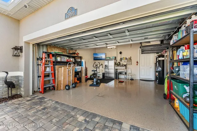 a view of a room with wooden floor and a ceiling fan