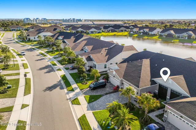 an aerial view of houses with a lake