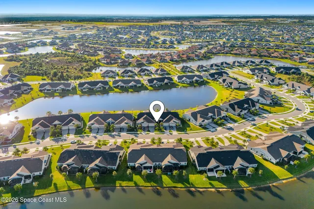 an aerial view of a pool patio chairs and a fire pit