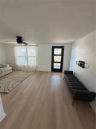 a view of wooden floor and windows in a room
