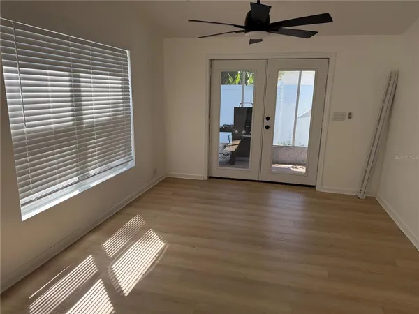 a view of a livingroom with wooden floor and a window