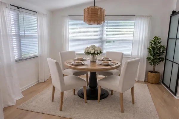 a view of a dining room with furniture window and wooden floor