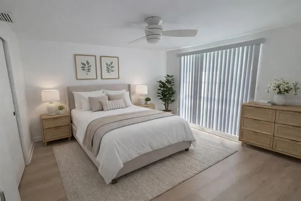 a bedroom with a bed and a chandelier