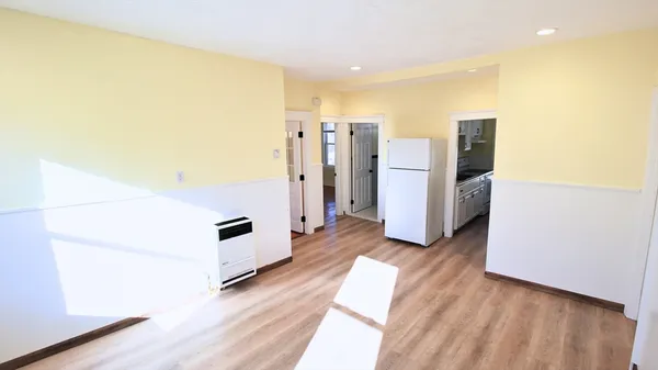 a view of a kitchen with furniture and an empty room