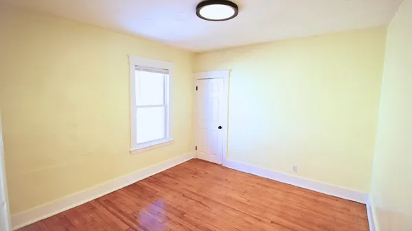 a view of a room with wooden floor and bathroom