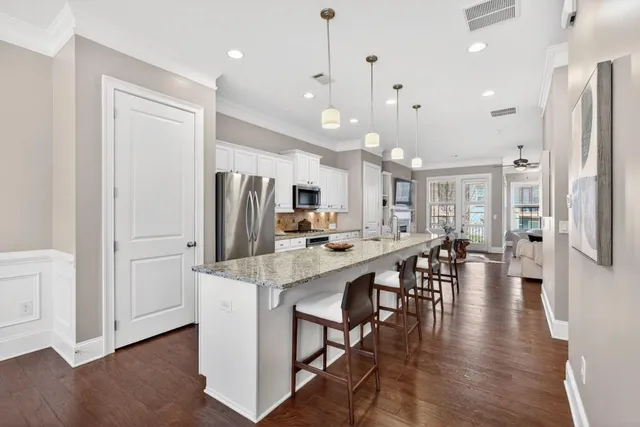a large kitchen with a table and chairs