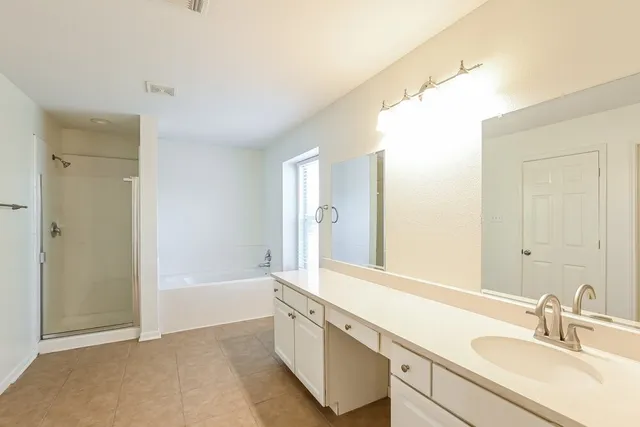 a bathroom with a sink a mirror and a bathtub