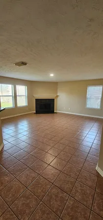 a view of a livingroom with an empty space and a window