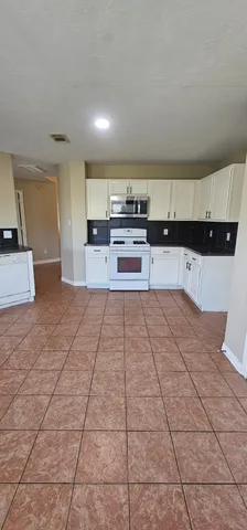 a view of staircase with wooden floor and chandelier
