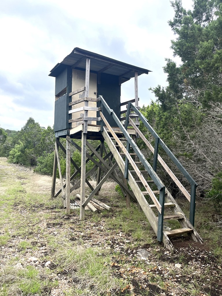 178 North Ringtail Road Camp Wood, TX 78833 - Photo 25 of 62 a backyard of a house with wooden stairs and stairs