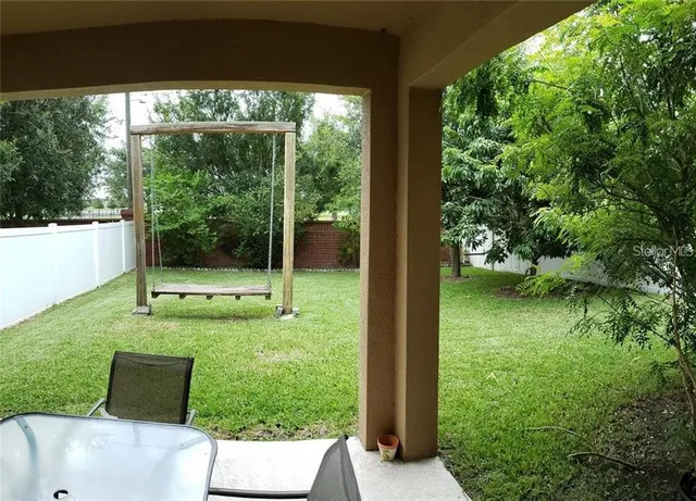 a view of backyard with trampoline