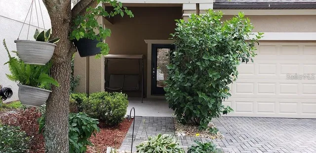 a view of a house with a yard and plants