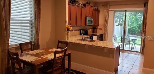 a kitchen with a table chairs and a window