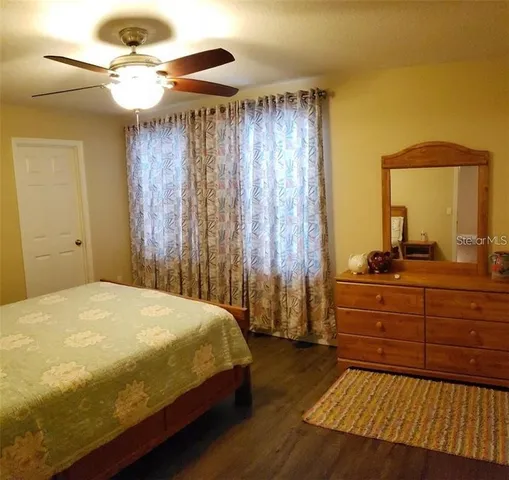 a bedroom with a bed and a dresser