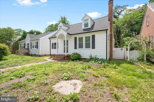 a front view of house with yard and trees around