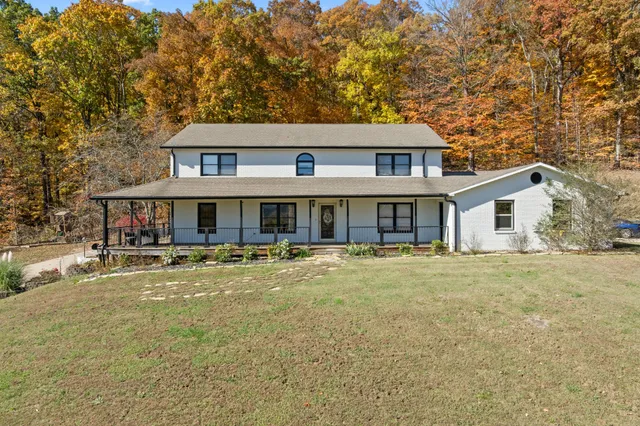 a front view of a house with a yard and balcony