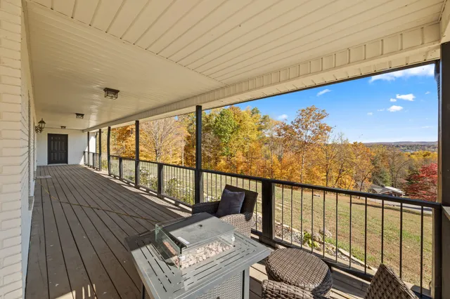 a view of a hallway with wooden floor and windows