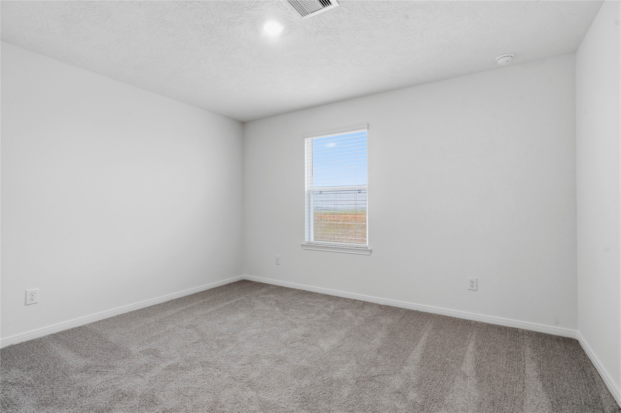 2503 Spruce Hl Road Beasley, TX 77417 - Photo 24 of 31 This secondary bedroom offers comfort and style with plush carpeting, neutral paint tones, recessed lighting, large window, and a generously sized closet.