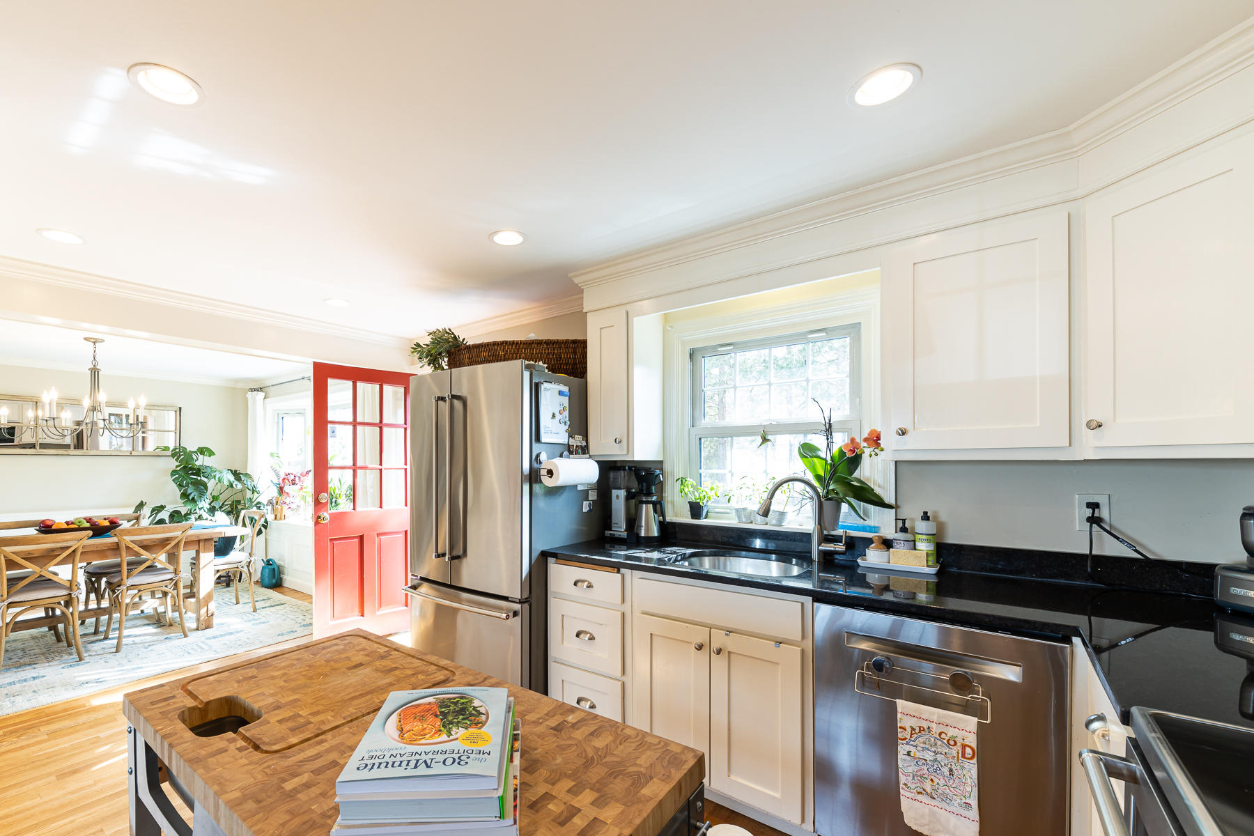 27 Chipman Road Sandwich, MA 02563 - Photo 11 of 44 a kitchen with stainless steel appliances granite countertop a stove a sink a refrigerator and a granite counter tops with white cabinets