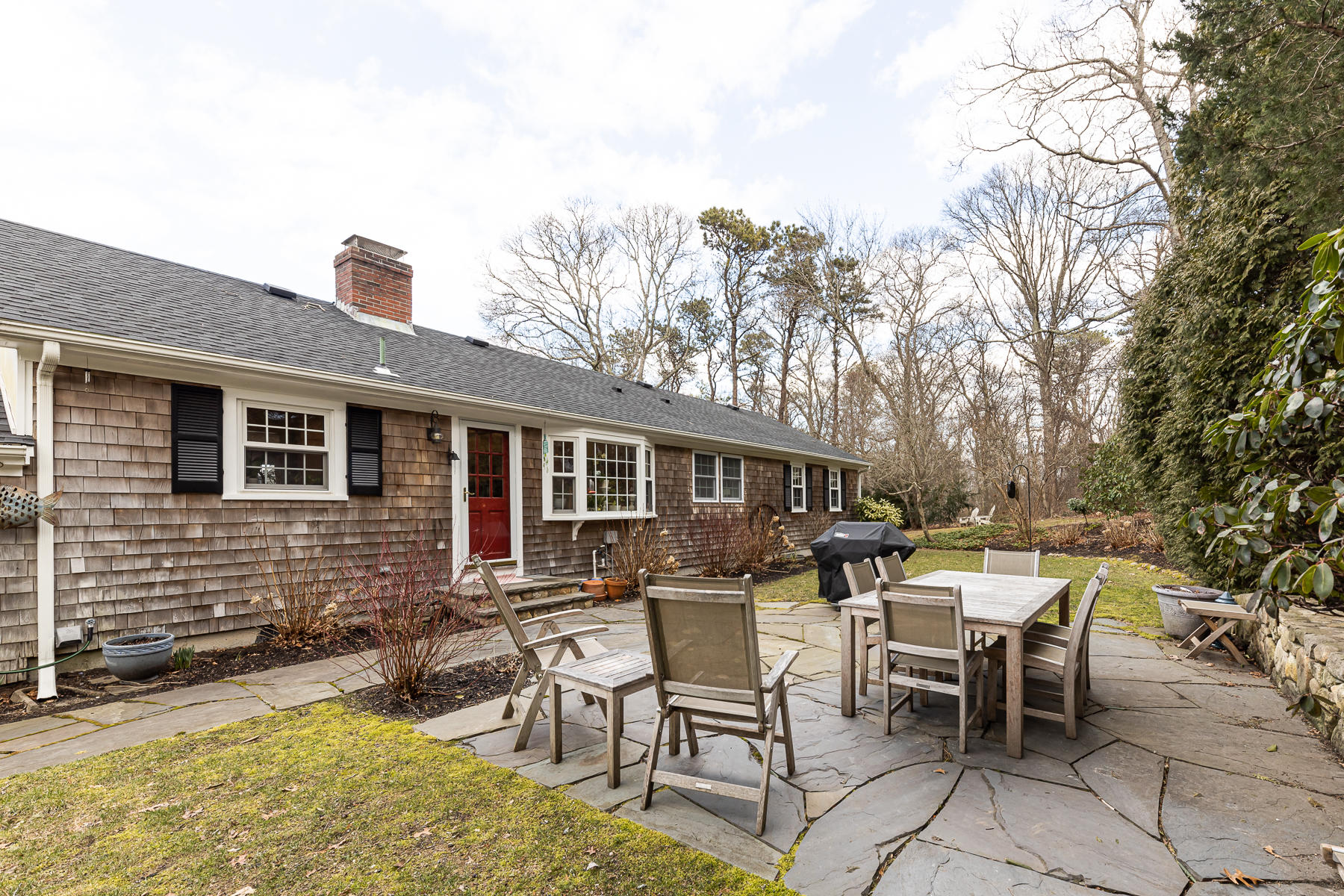 27 Chipman Road Sandwich, MA 02563 - Photo 39 of 44 a view of a patio with table and chairs and wooden fence