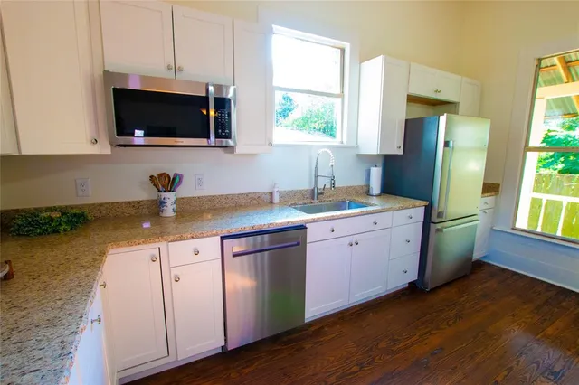 a kitchen with sink cabinets and window