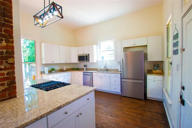 a kitchen with refrigerator a stove a sink and a refrigerator