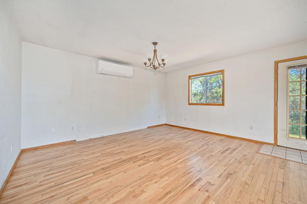 4751 Meadowview Acres Road Cool, CA 95614 - Photo 11 of 51 a view of an empty room with wooden floor and a window
