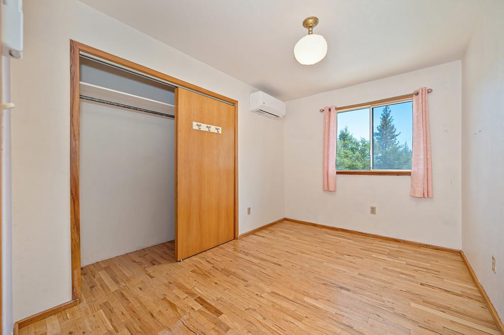 4751 Meadowview Acres Road Cool, CA 95614 - Photo 26 of 51 a view of an empty room with wooden floor and windows
